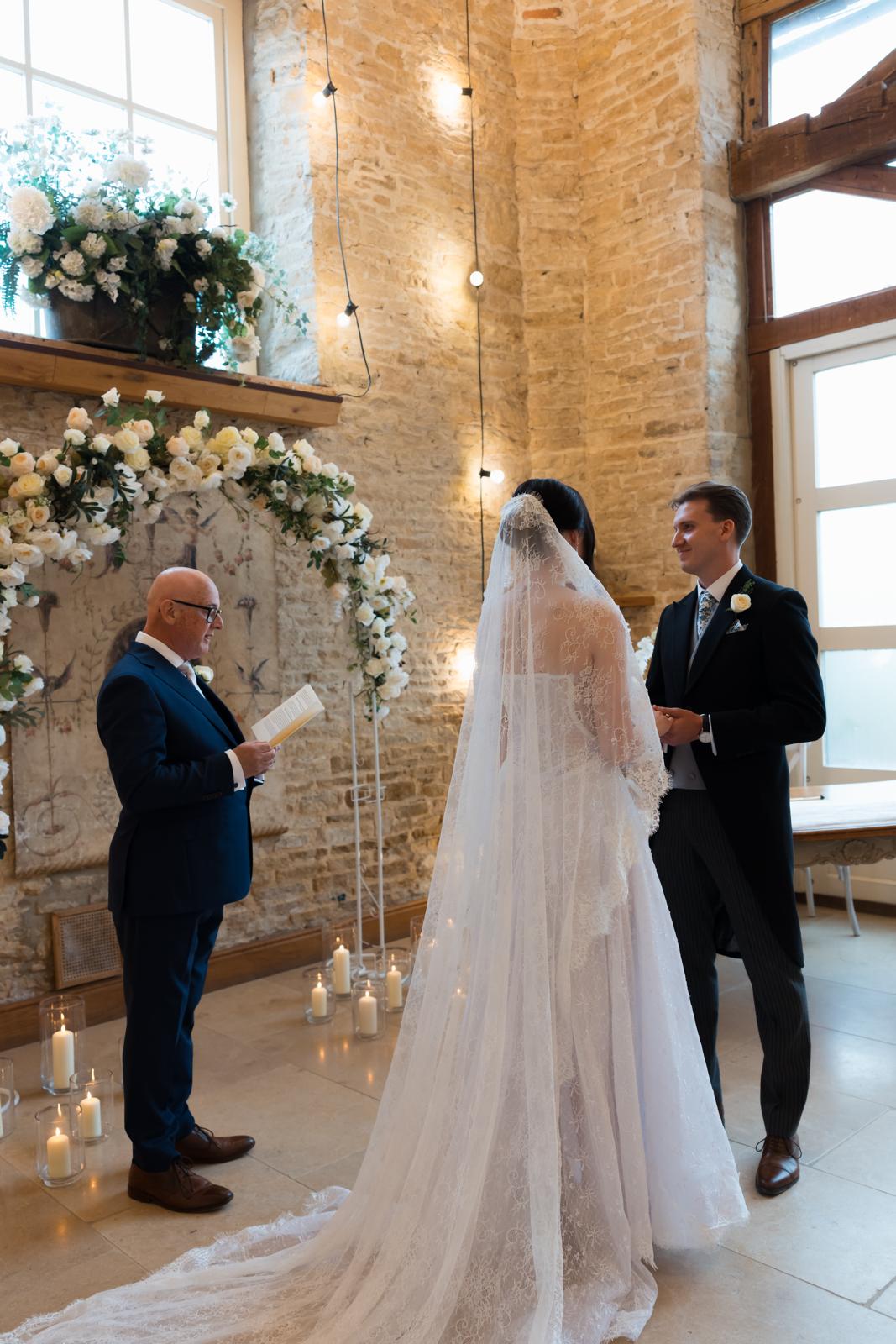 David and Johanna at the altar with wedding guests looking on